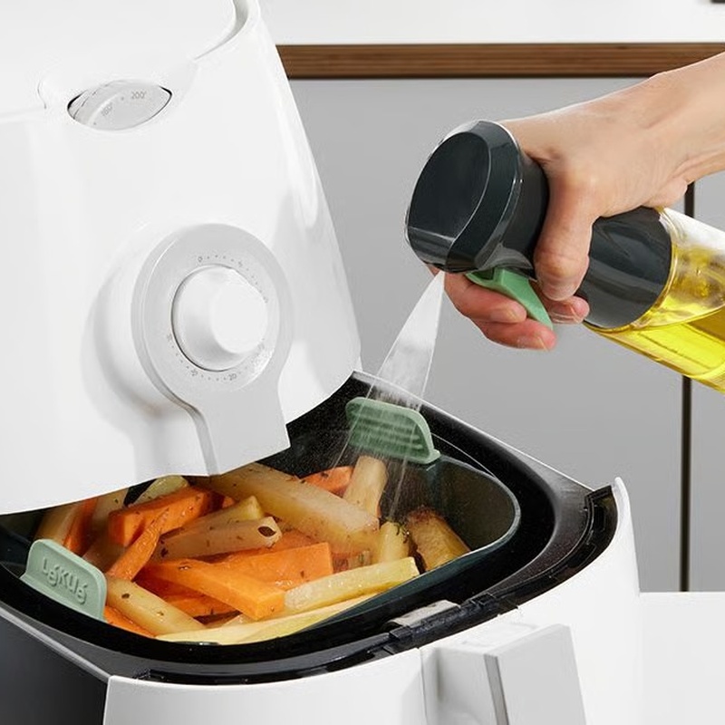 Aceitera Spray Lékué pulverizando aceite sobre alimentos en freidora de aire